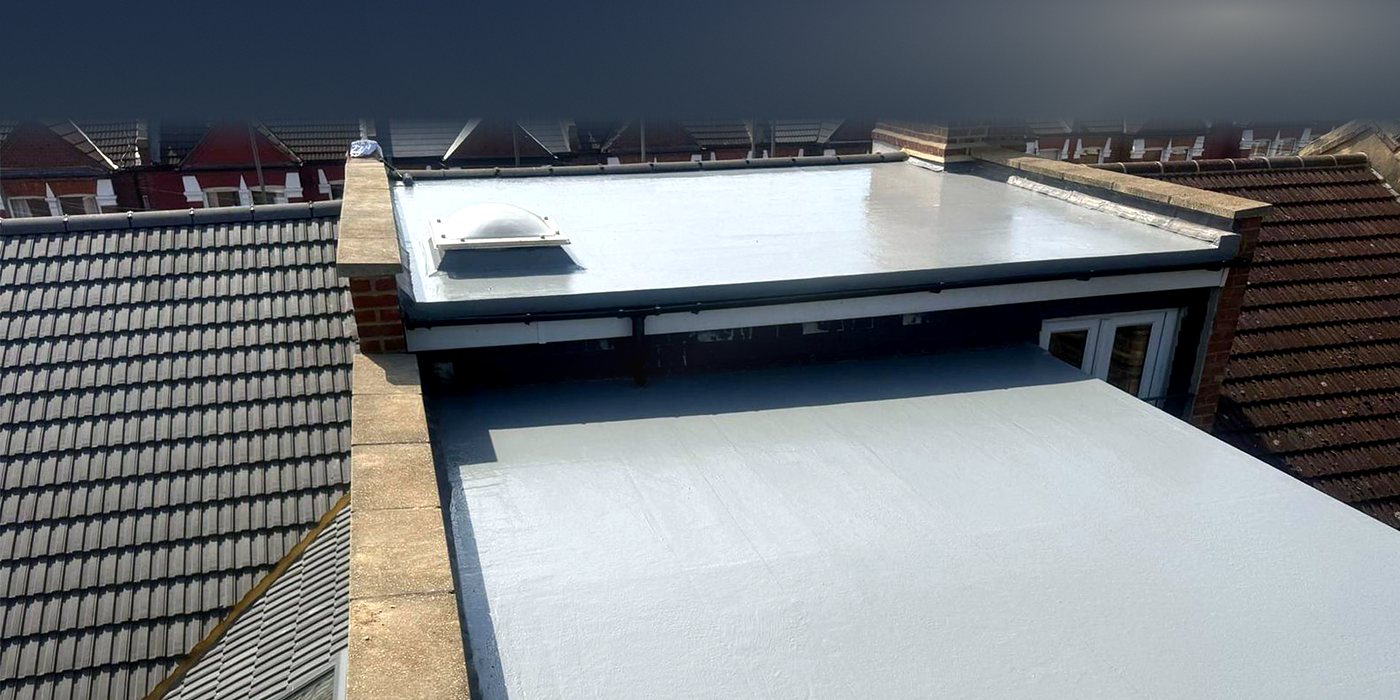 A grey fibreglass flat roof on a rear extension