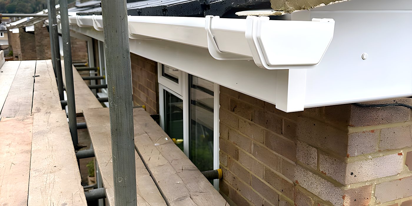 A gutter run and its outlet on a brick house