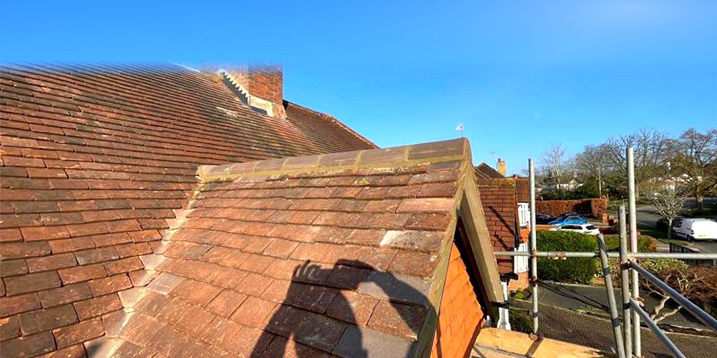 A clay tiled roof with the scaffold up for repairs