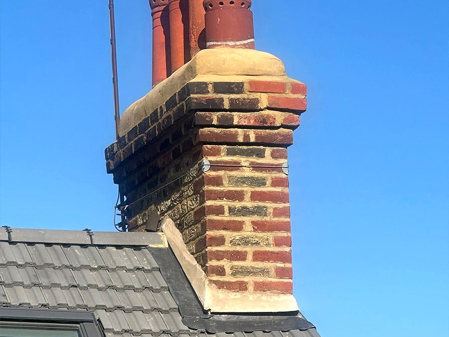 Chimney stack repointed with fresh mortar and new lead flashing at the roof line
