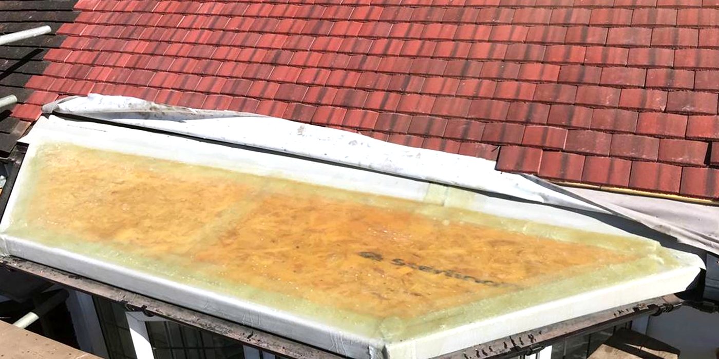 Roofing work in Horsham: red plain clay tiles beside a felt flat roof