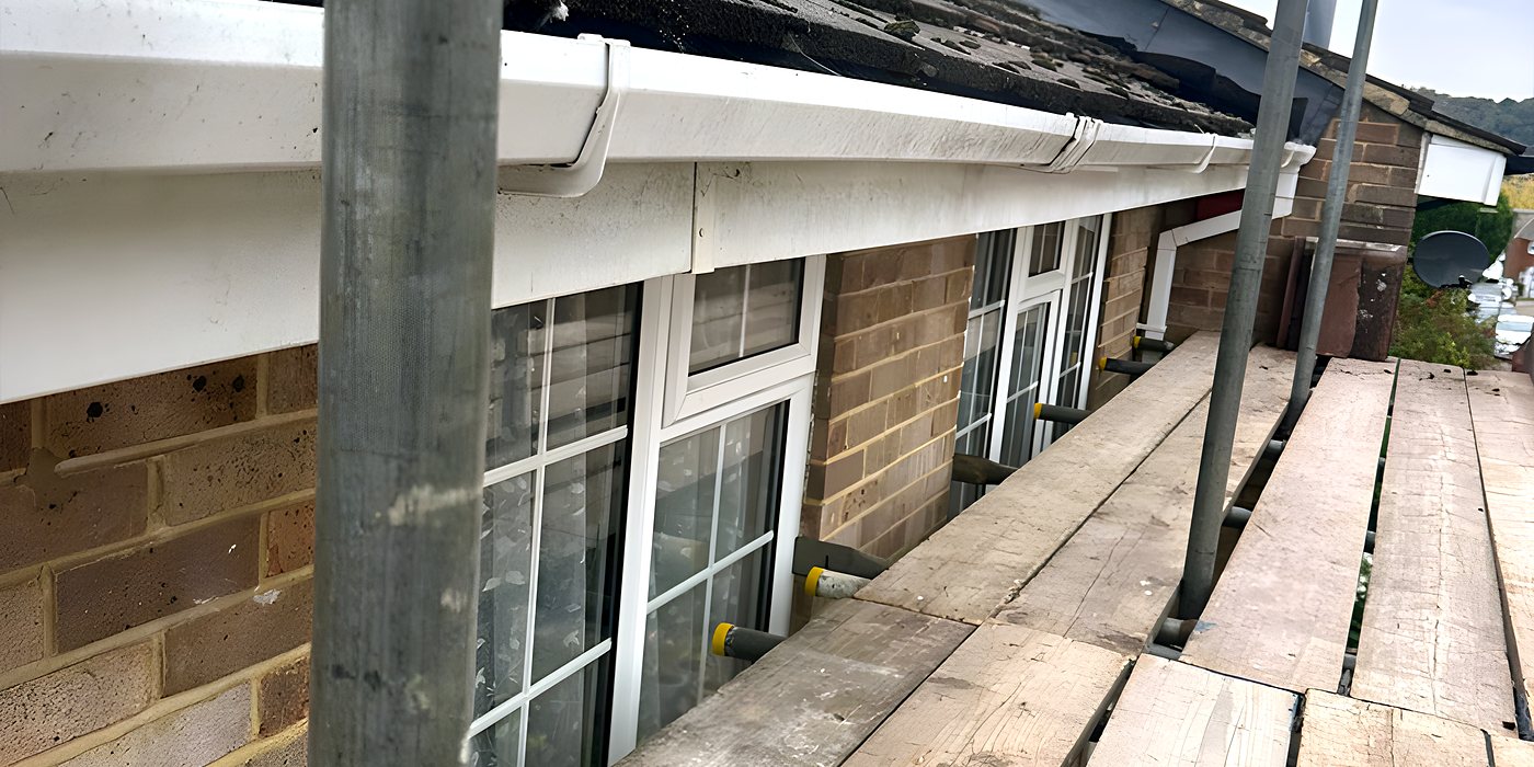 Roofing work in Leatherhead: new white fascia along the eaves of a bungalow