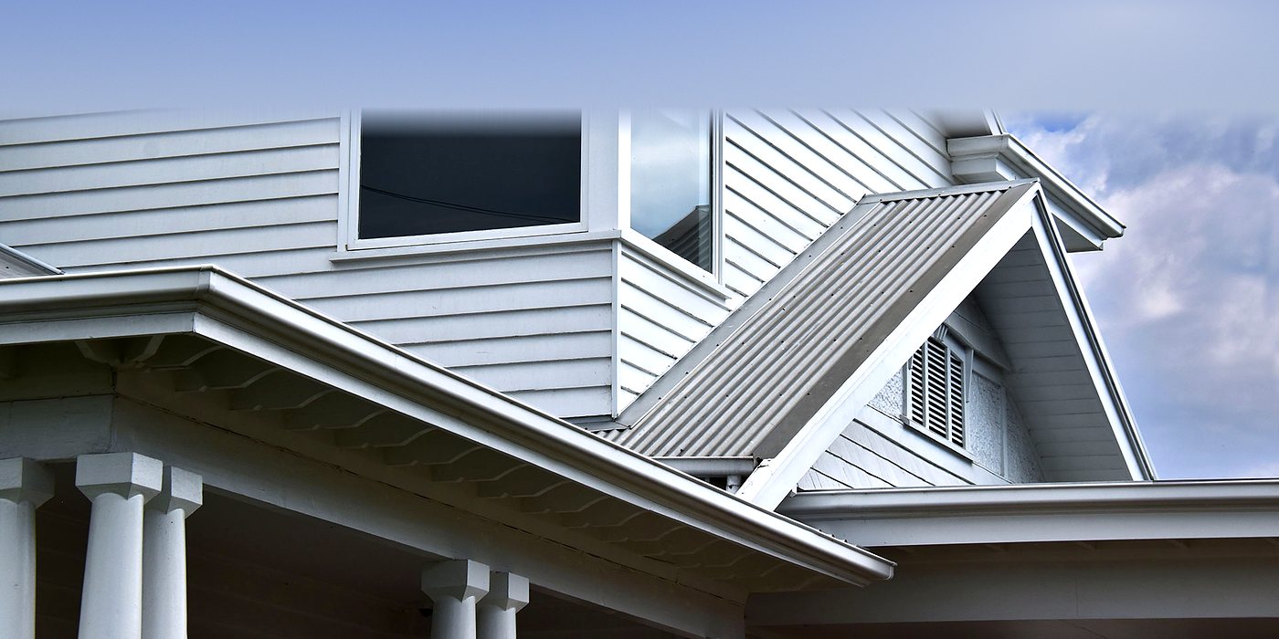 Roofing work in Wimbledon: a white dormer on a slate roof